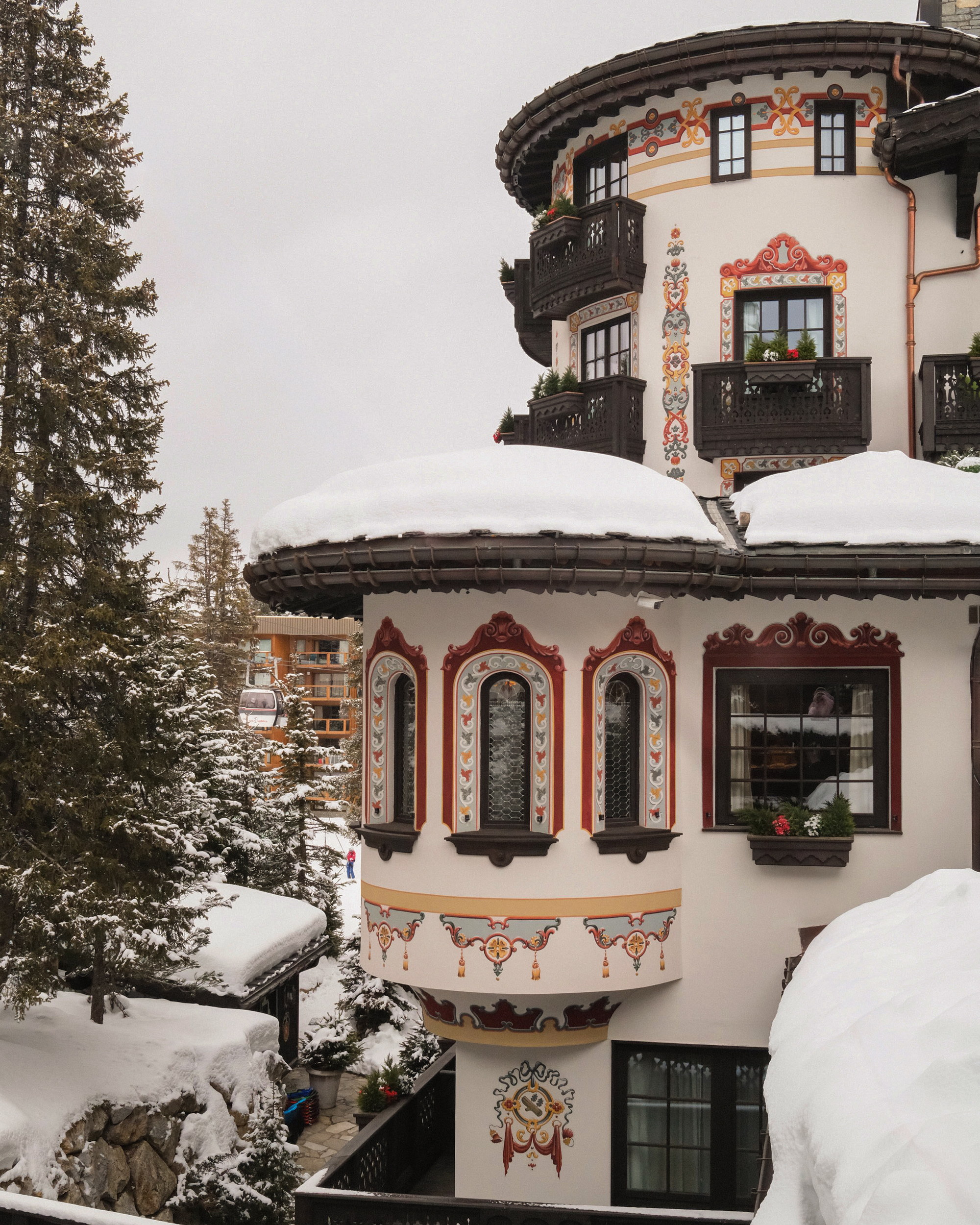 The tower and its bay, three painted arches beneath a roof of snow