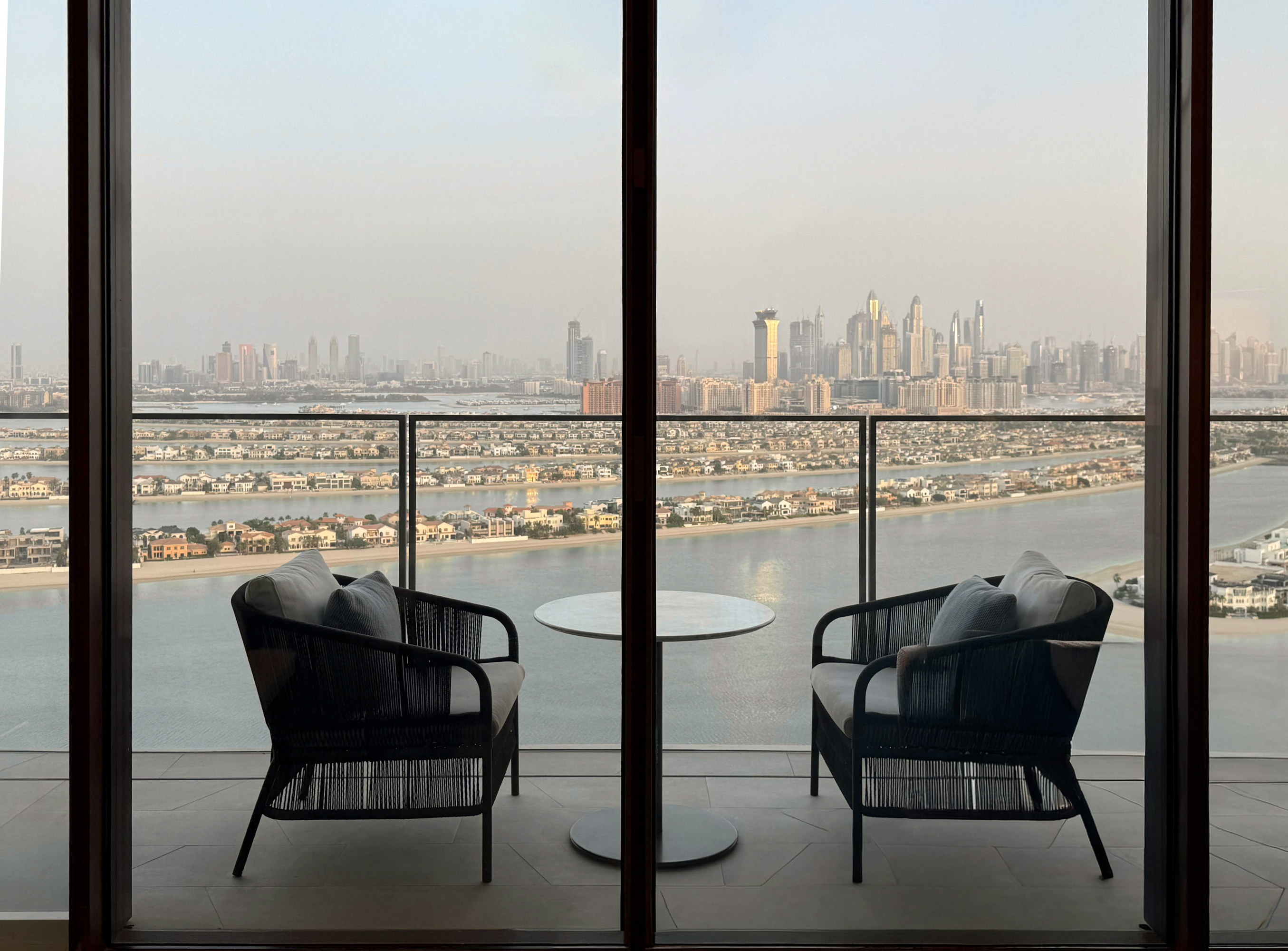 Two chairs on the balcony, the Palm and the skyline beyond