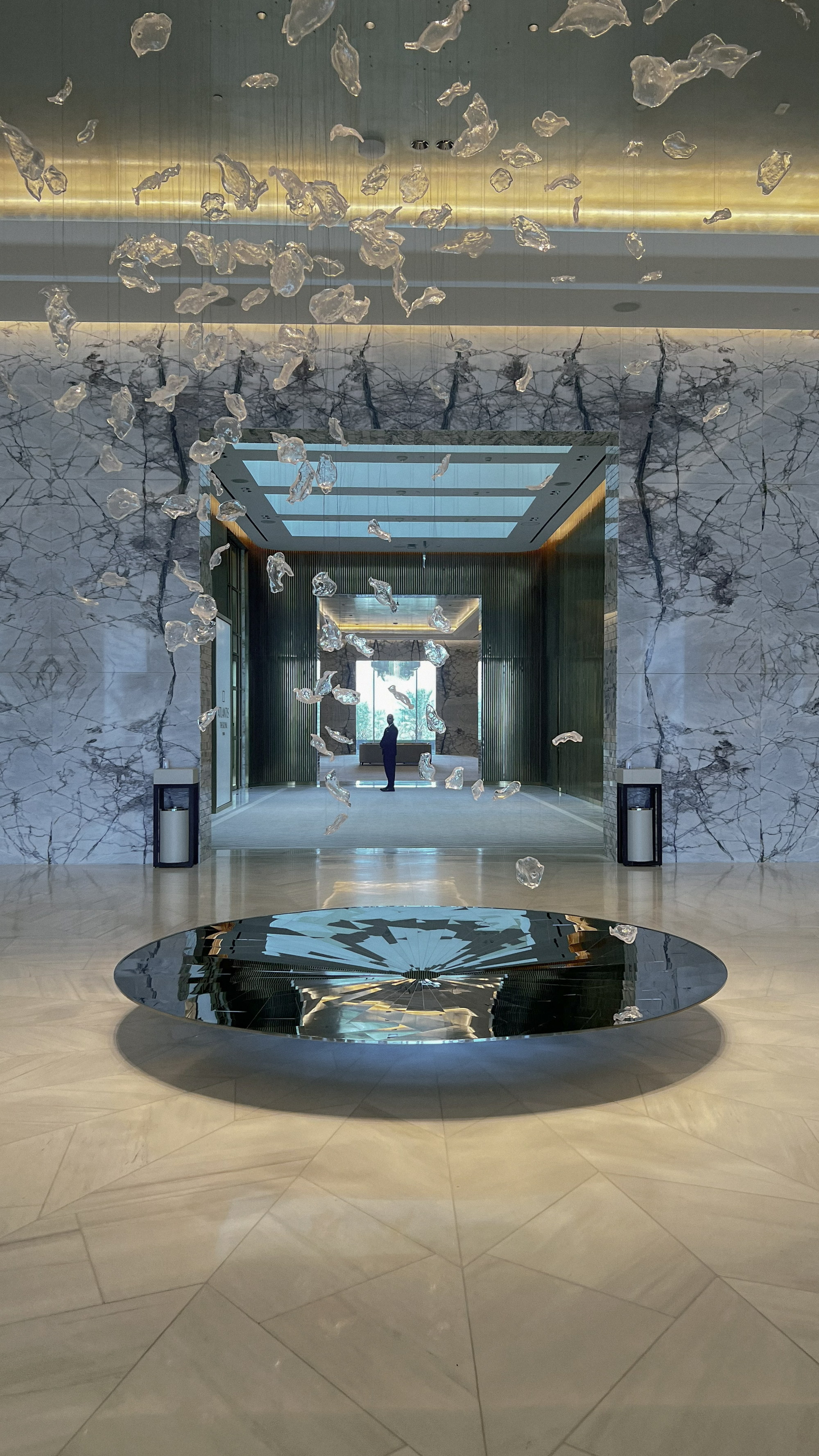 Glass suspended above the mirrored disc of the lobby