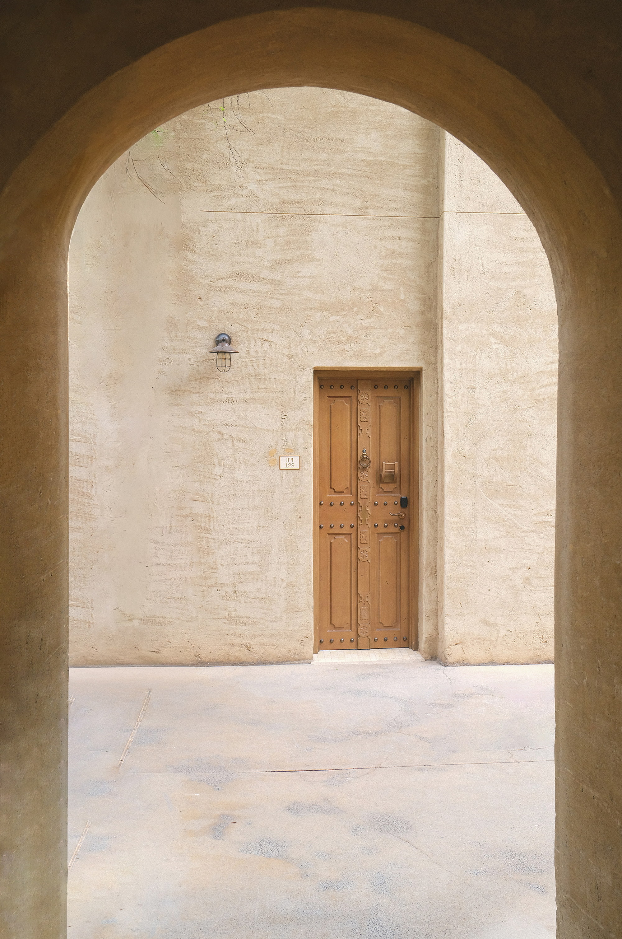 Door 129, closed beneath the balanced arch