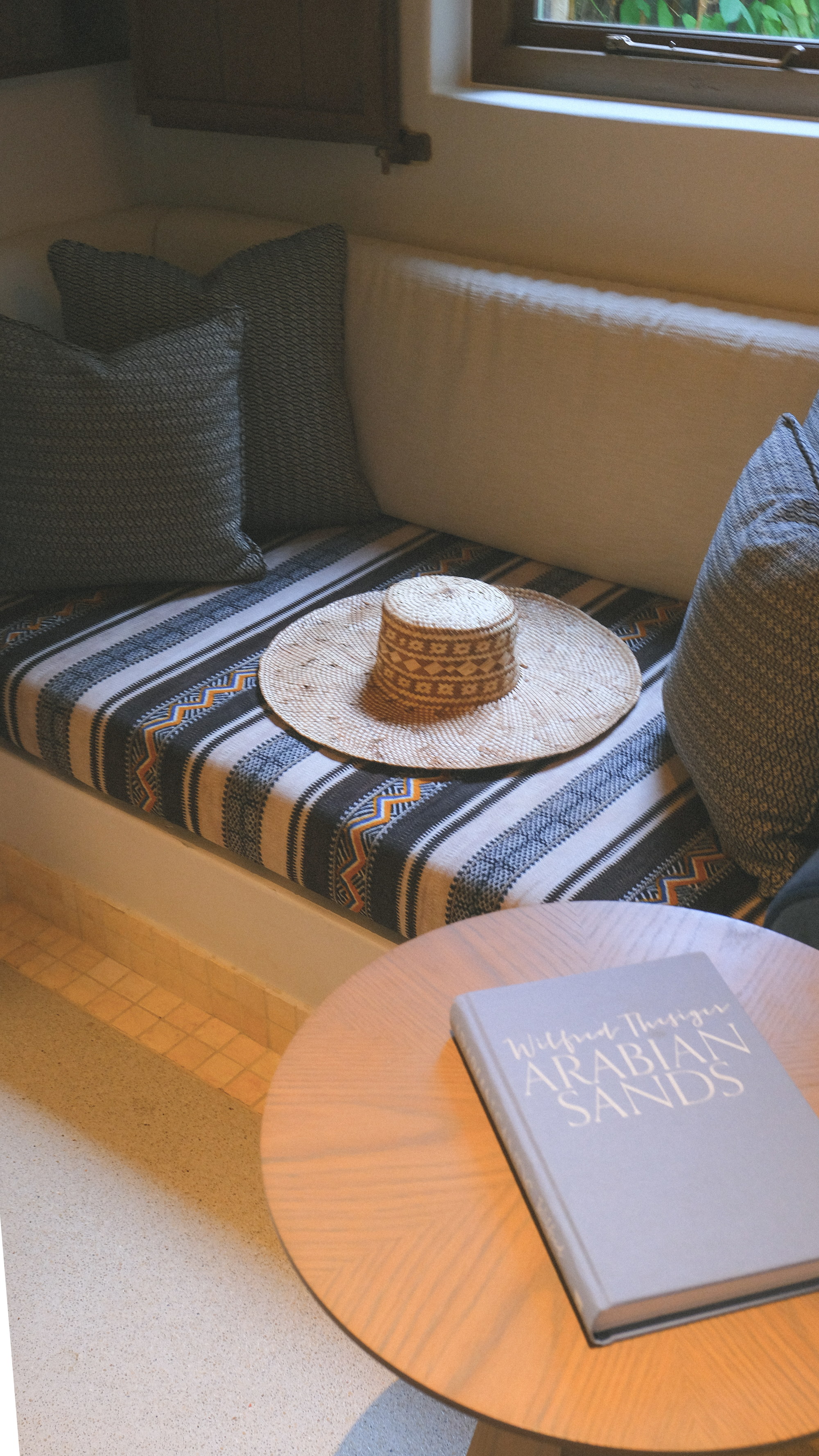 The majlis corner, a woven hat on sadu weave, Arabian Sands on the table