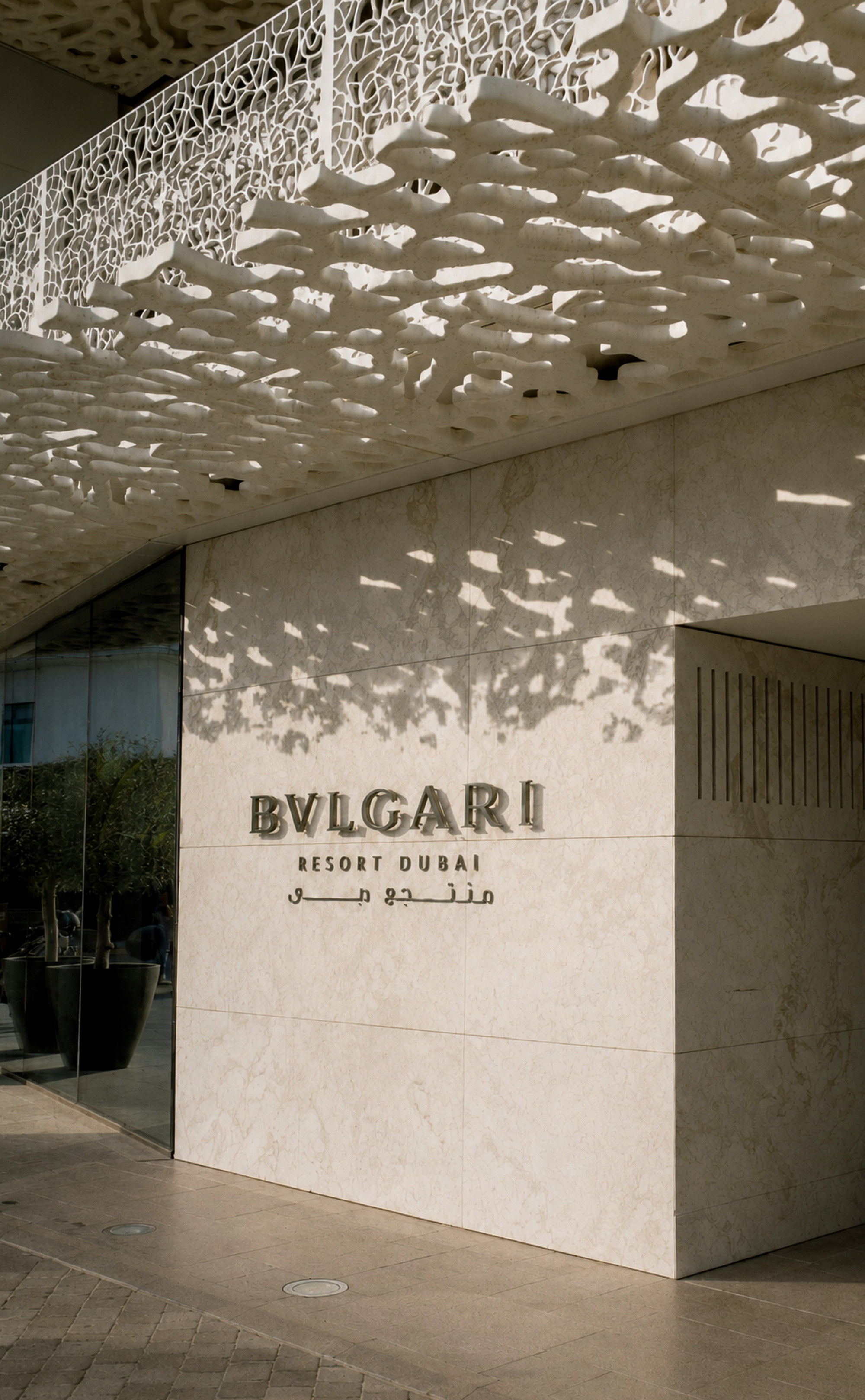 The marble entrance of Bulgari Resort Dubai beneath the coral canopy