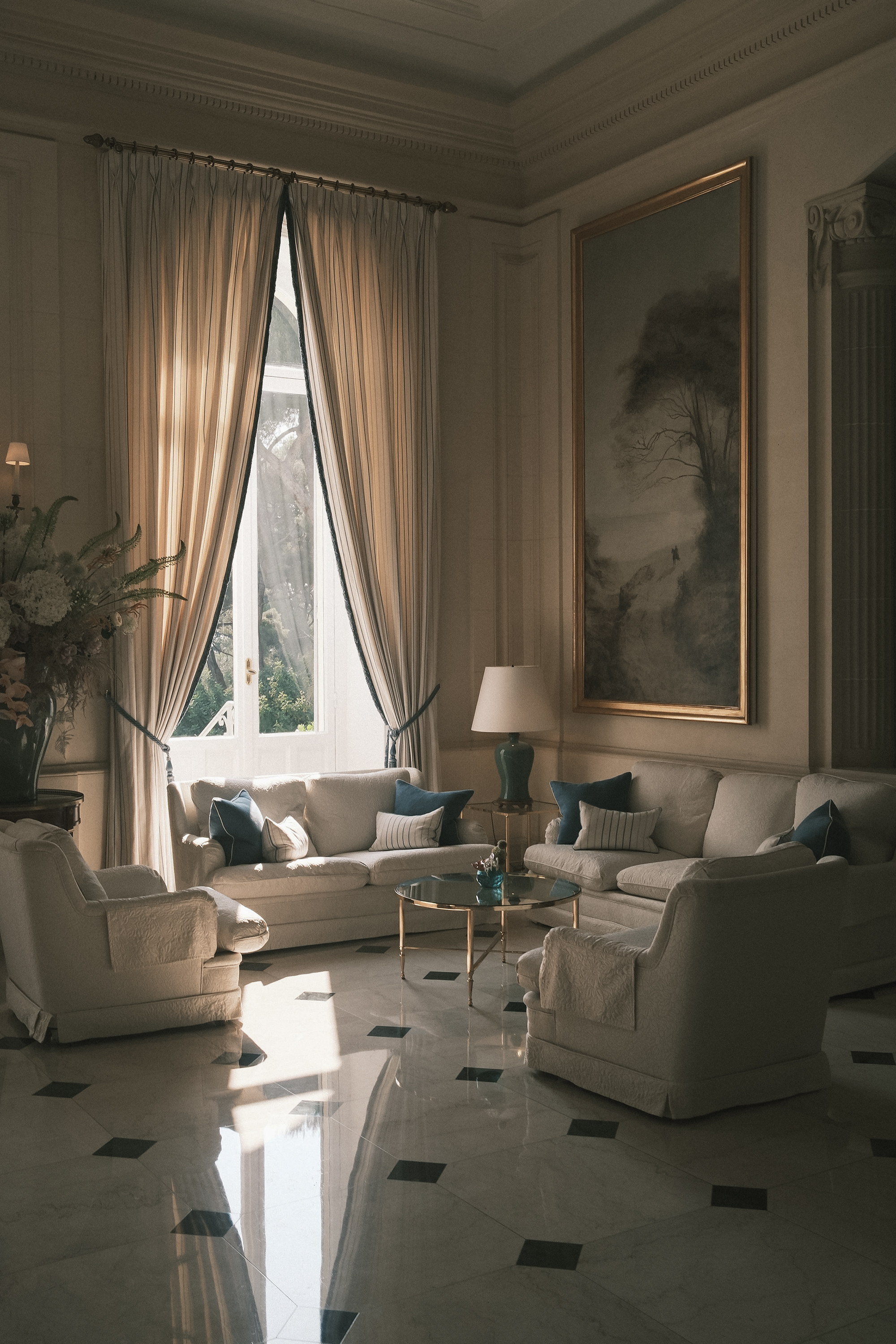 The salon corner, raked light on linen and brass