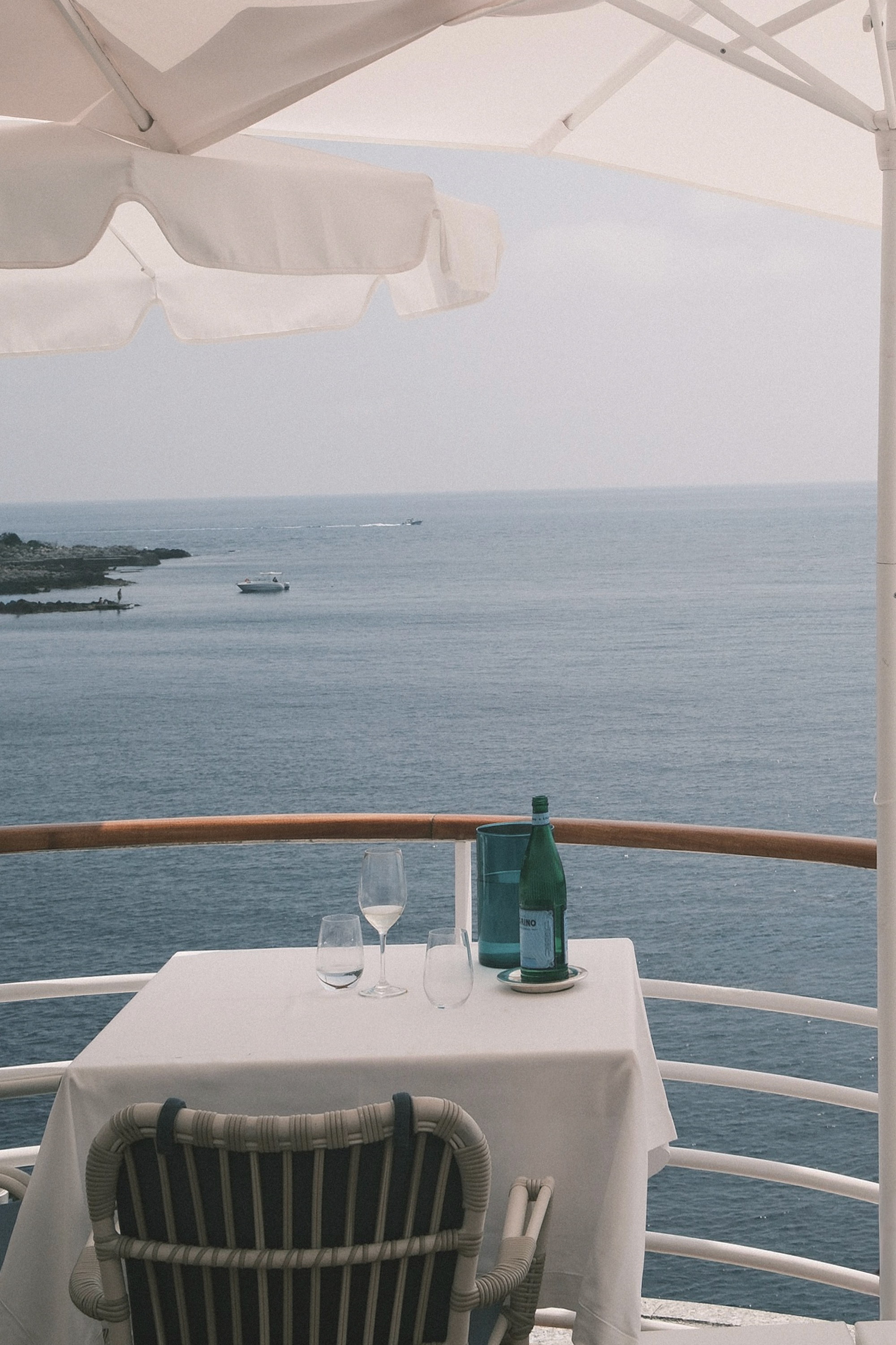 A table laid at the rail, the sea beyond