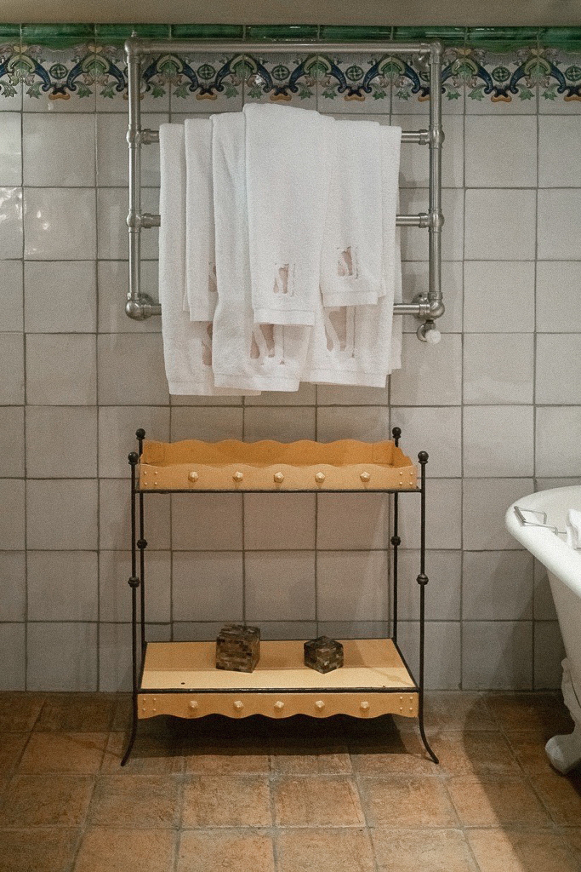 Towels on the rail, the frieze above, the yellow washstand below